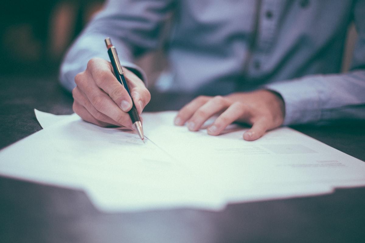 Signed legal documents and pen on a desk